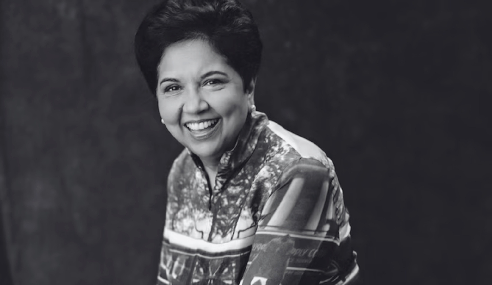 Indra Nooyi, Former CEO of Pepsi Co smiles at the camera. The image is black and white.