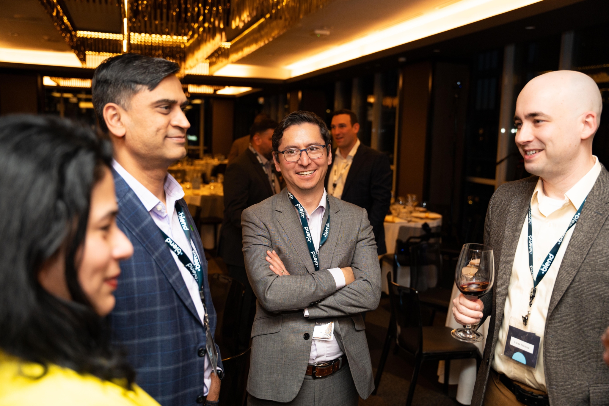 A group of C-suite professionals talk at a Blend community networking event.