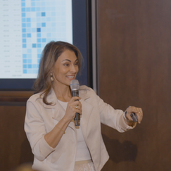 Sol Rashidi - the world's first Chief AI Officer - delivers a panel talk. She speaks into a microphone while smiling.