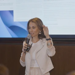 Sol Rashidi - the world's first Chief AI Officer - delivers a panel talk. She speaks into a microphone while smiling.