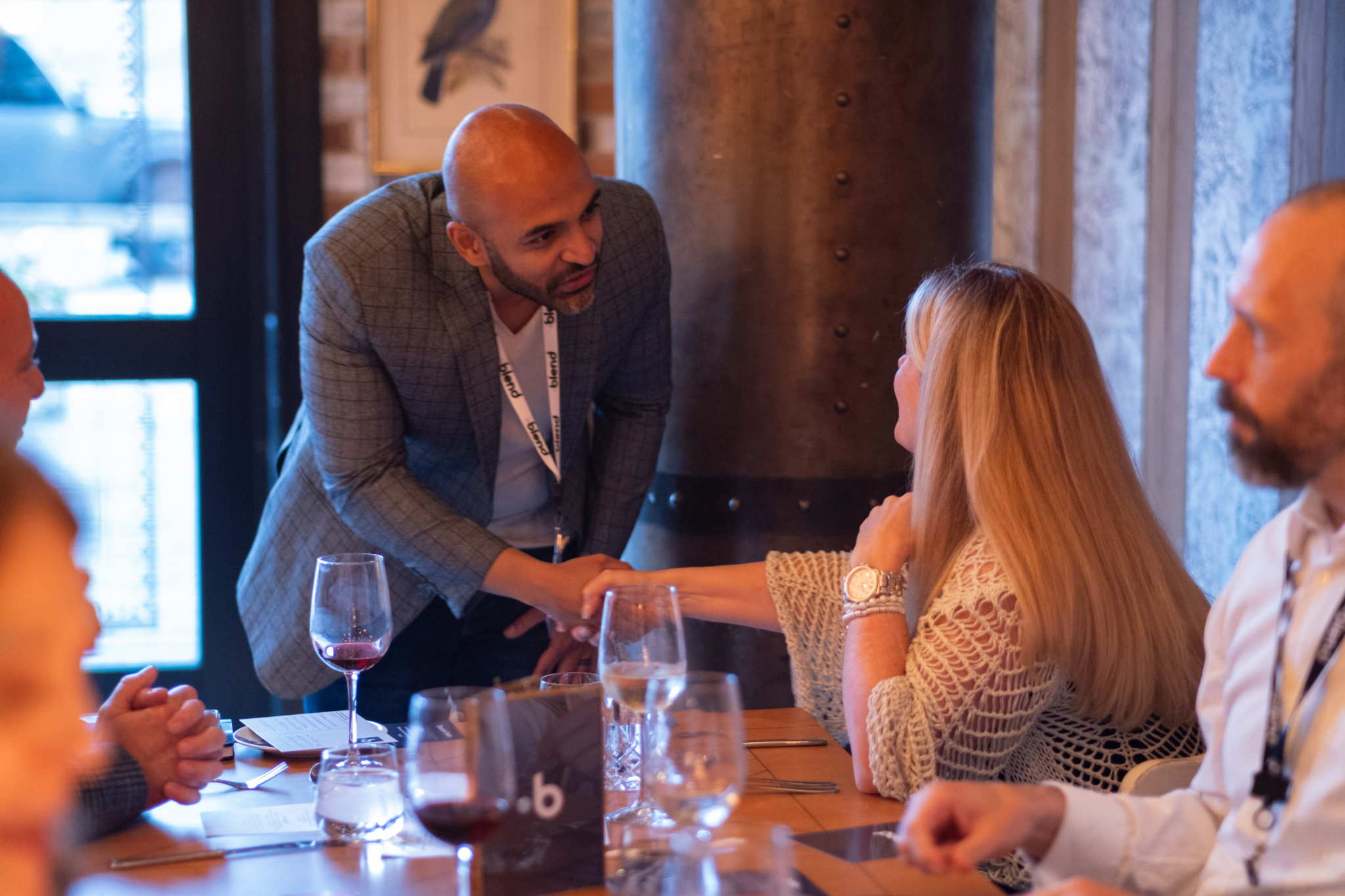 Two C-suite professionals introduce themselves to each other at a Blend community networking event.